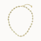 Gold necklace with clear stones on a white background