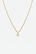 Gold necklace with a teardrop pendant on a white background