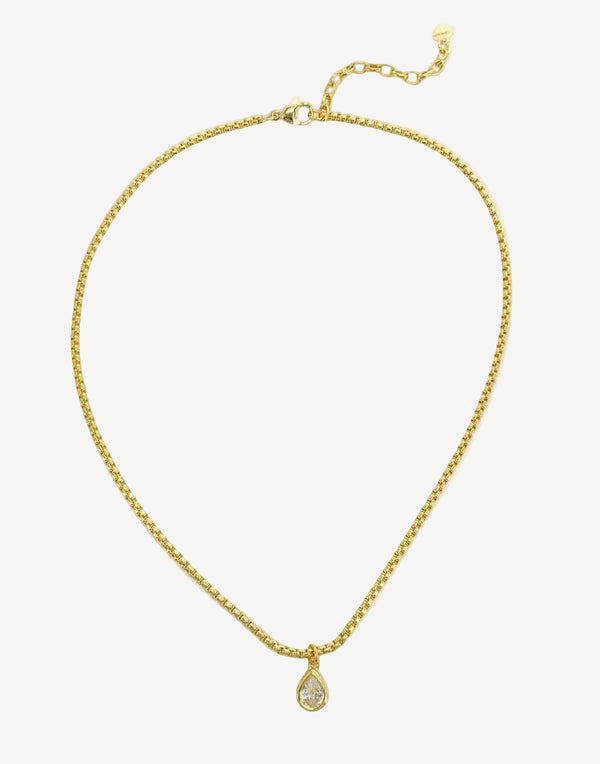 Gold necklace with a teardrop pendant on a white background
