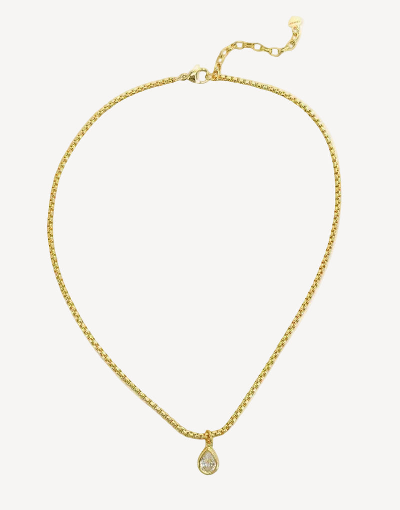 Gold necklace with a teardrop pendant on a white background