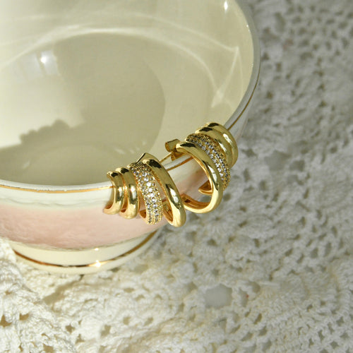Gold bracelet on a white ceramic plate with lace background