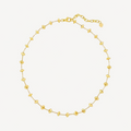 Gold beaded necklace on a white background