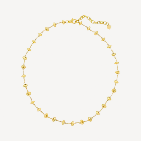Gold beaded necklace on a white background